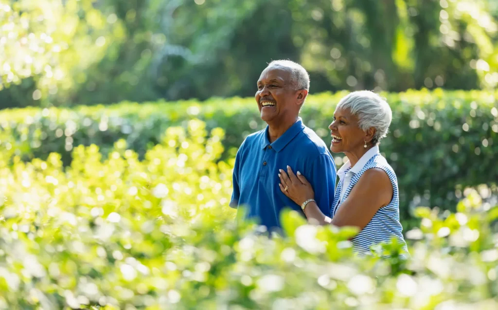 happy senior couple in sunny garden