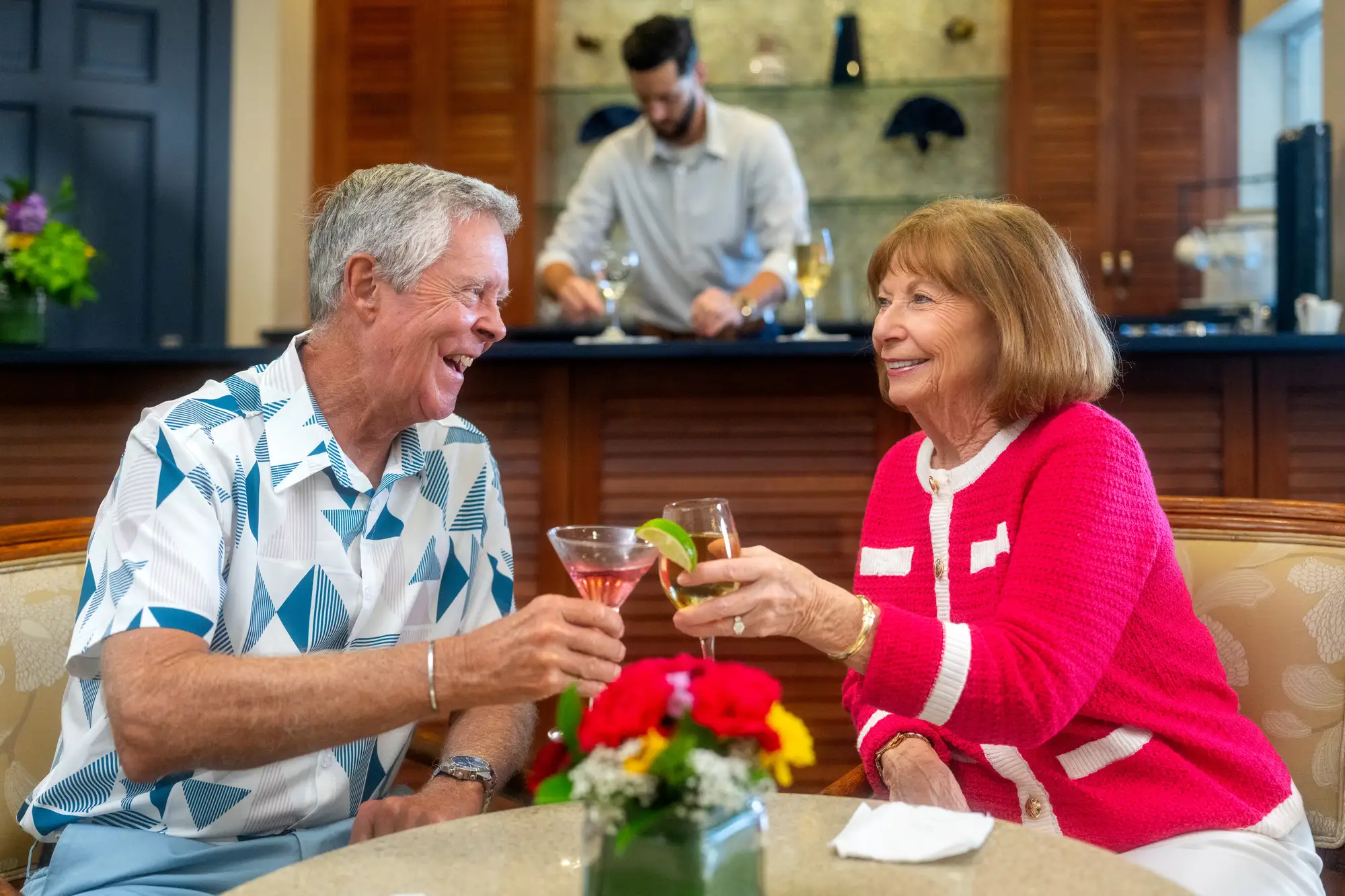 Sandhill Cove couple toasting to the best time to move to a retirement community in Palm City, Florida, is 2026.