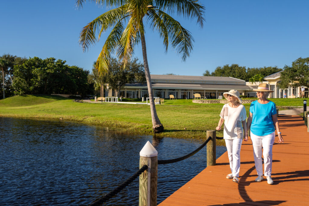 Senior couple walking out on pier near Sandhill Cove in FL while thinking about the Independent Living apartment The Pelican at Waterside 