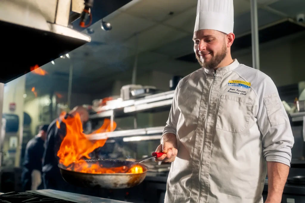Sandhill Cove Chef Aron flambes a delicious dish for residents at Sandhill Cove in Palm City, FL.
