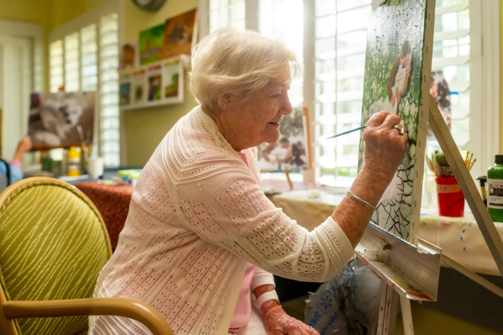Woman paints in the an Art Studio at Sandhill Cove in Palm City, Florida.