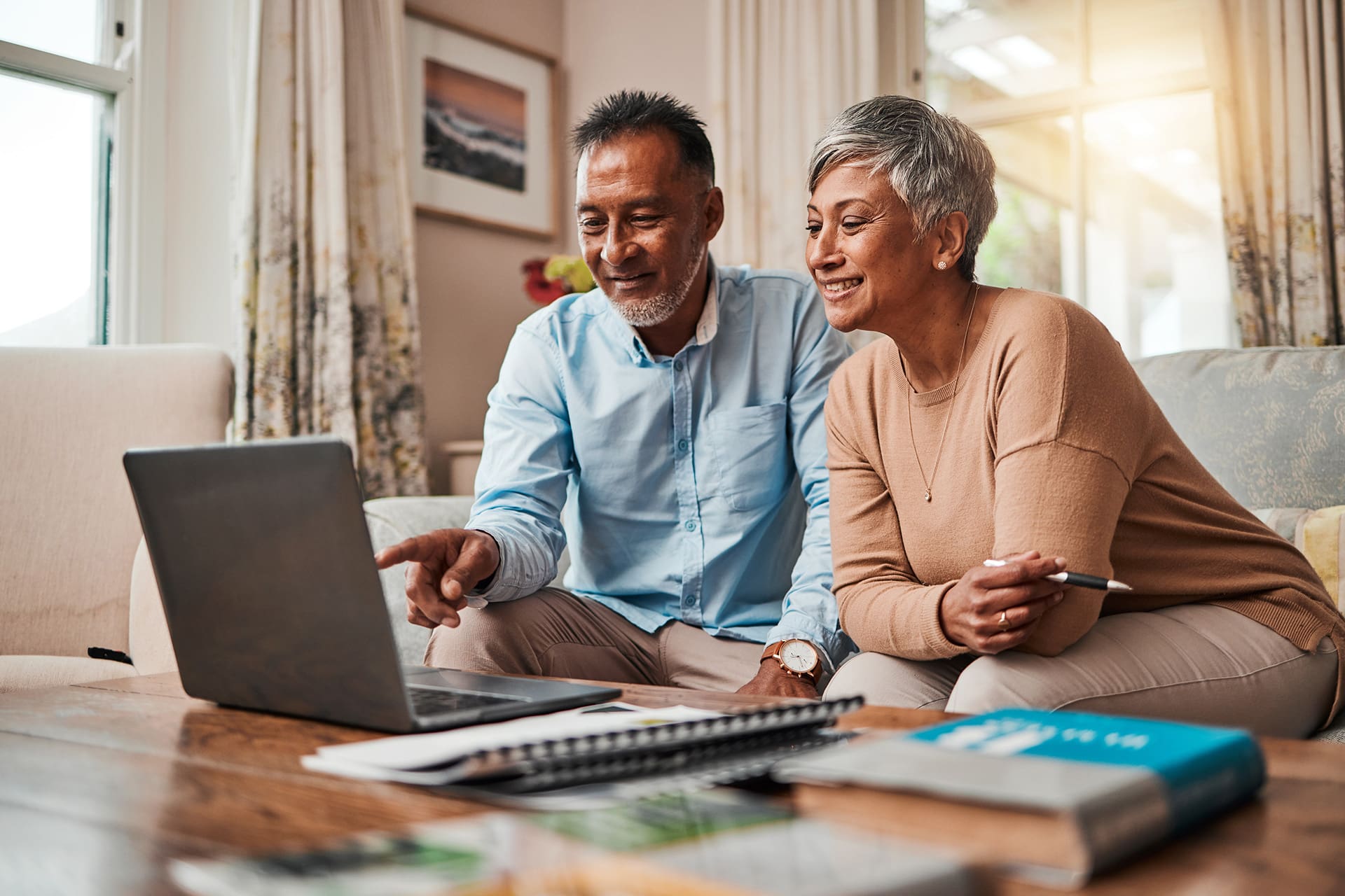 A senior couple look at their computer, representing them choosing a senior living community. How to choose the right senior living community, Palm City, FL