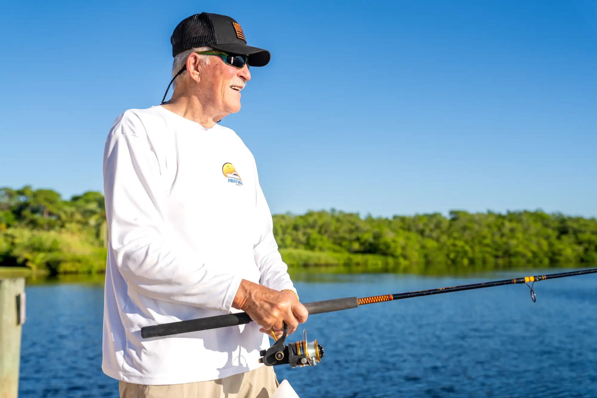 Senior man fishing on the dock at Sandhill Cove, one of the best outdoor activities for seniors.